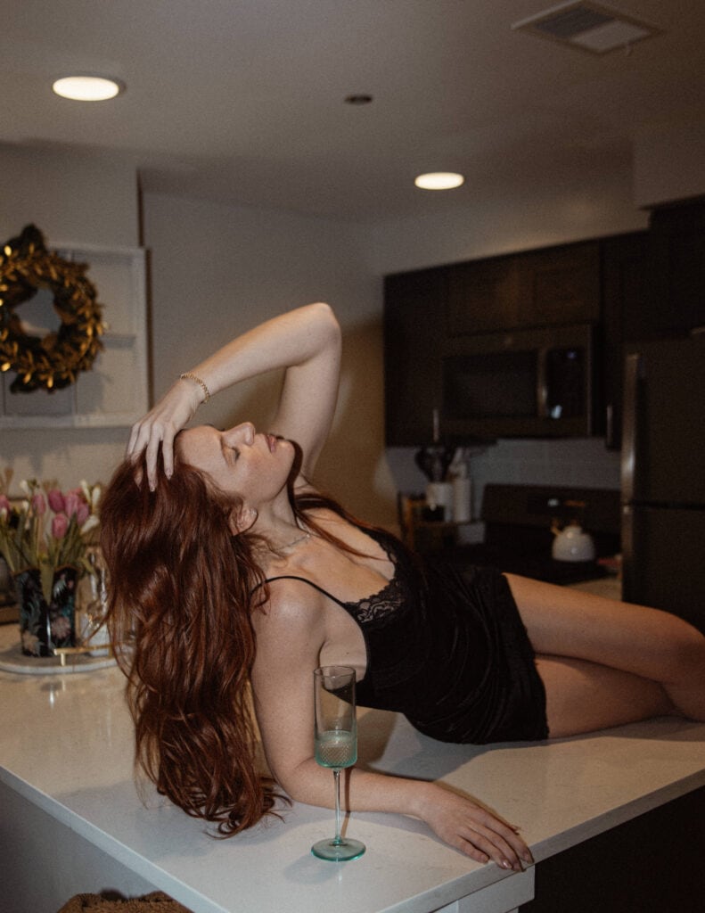 Woman lounging on kitchen counter - sensual photo