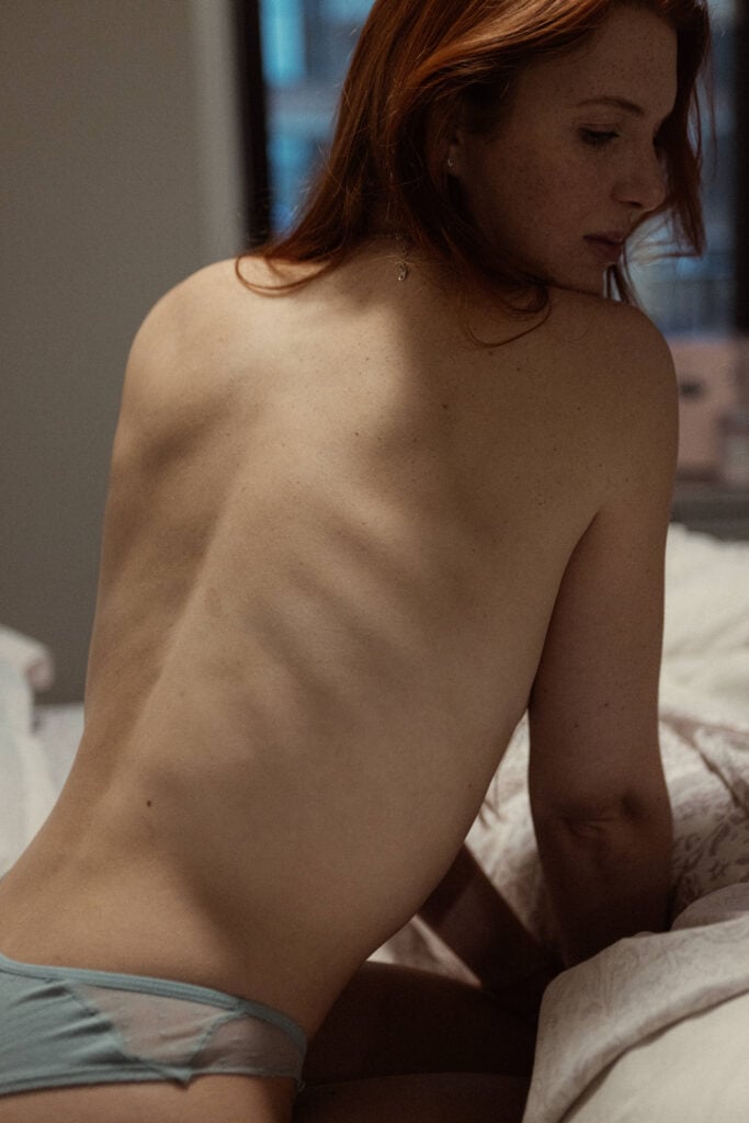 Close-up of a beautiful woman's back in bed - Photo