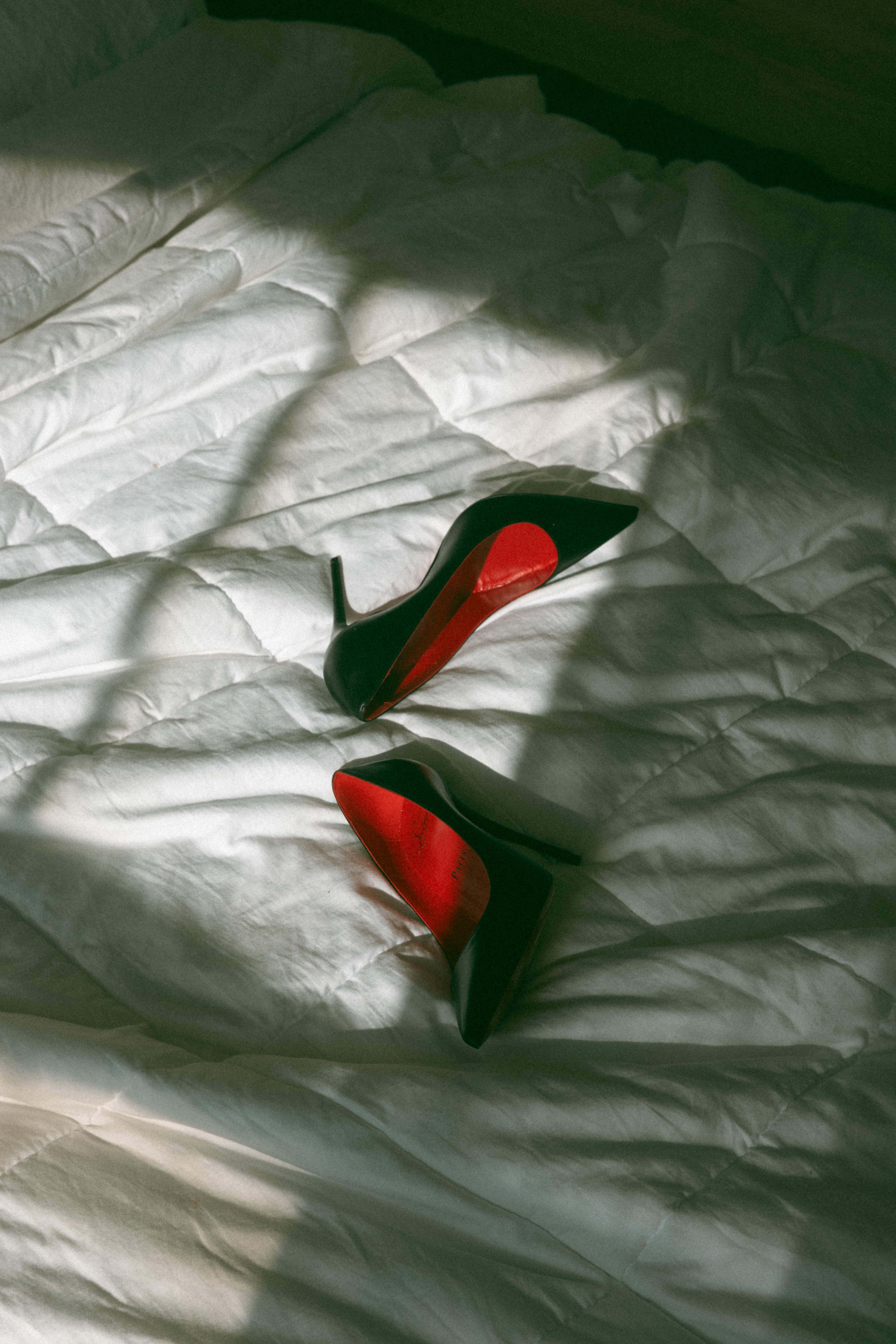 creative boudoir photo ideas from louboutins on a bed with shadows splayed across them 