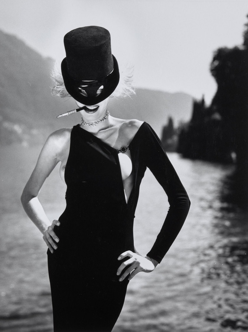 a female photoshoot of a woman in all black and a black hat and mask