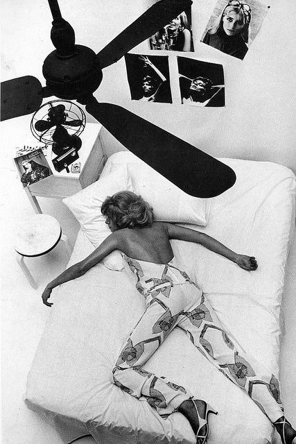 a woman laying on a bed during a female photoshoot