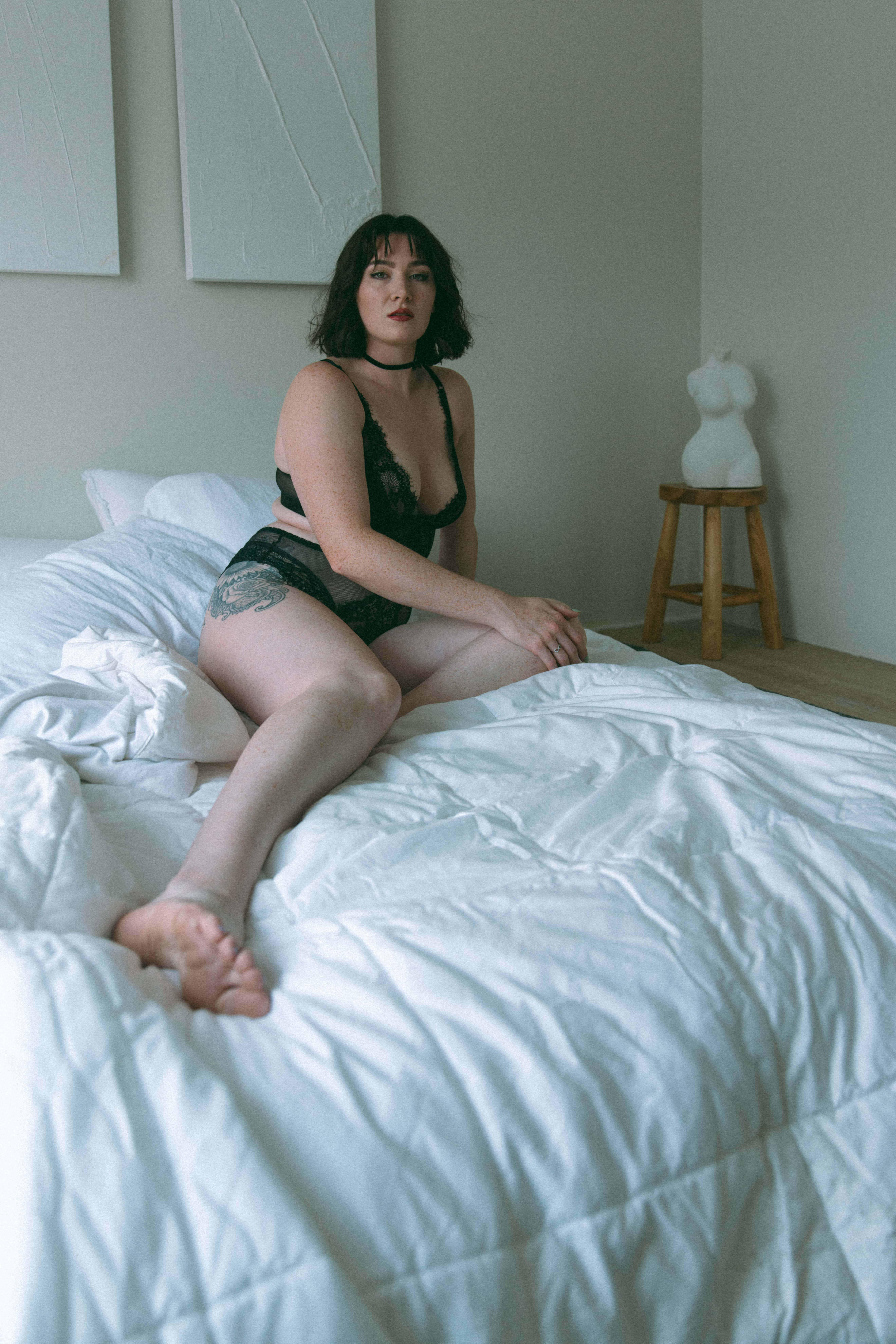 a woman in intimates on a bed captured by a maryland boudoir photographer