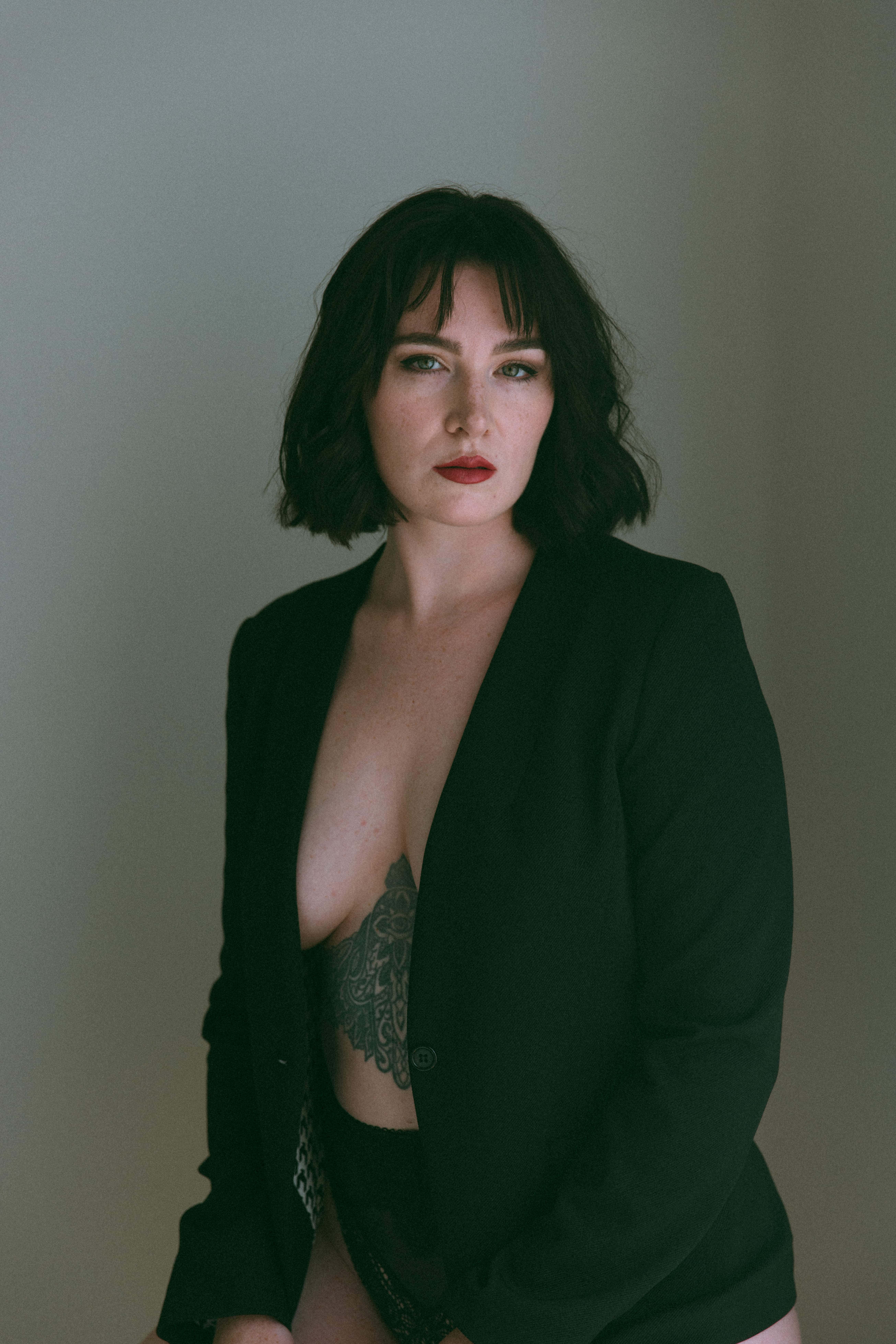 a portrait of woman wearing a blazer with nothing underneath captured by a Maryland boudoir photographer