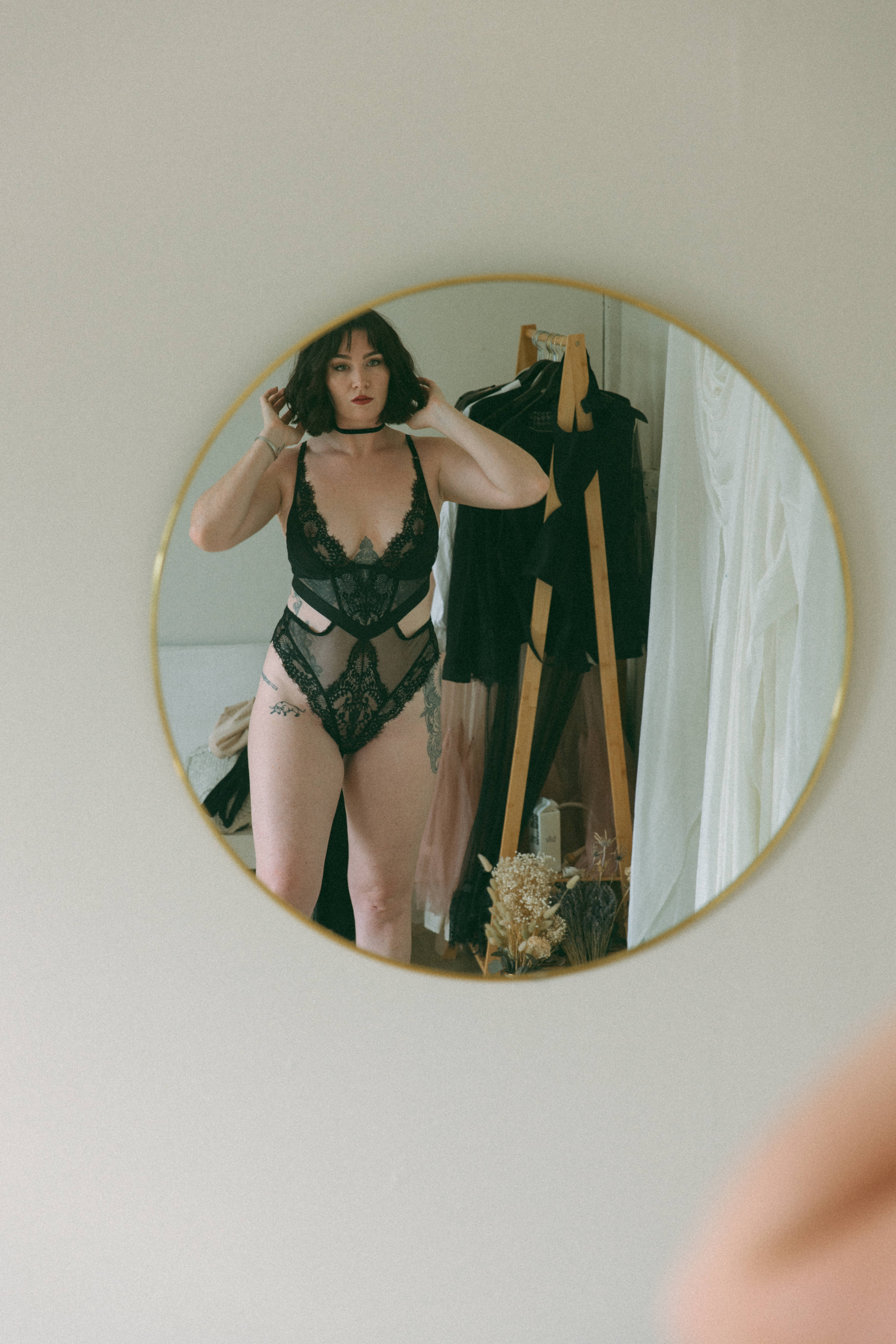 a woman in black intimates standing with her reflection in the mirror captured by a Maryland boudoir photographer