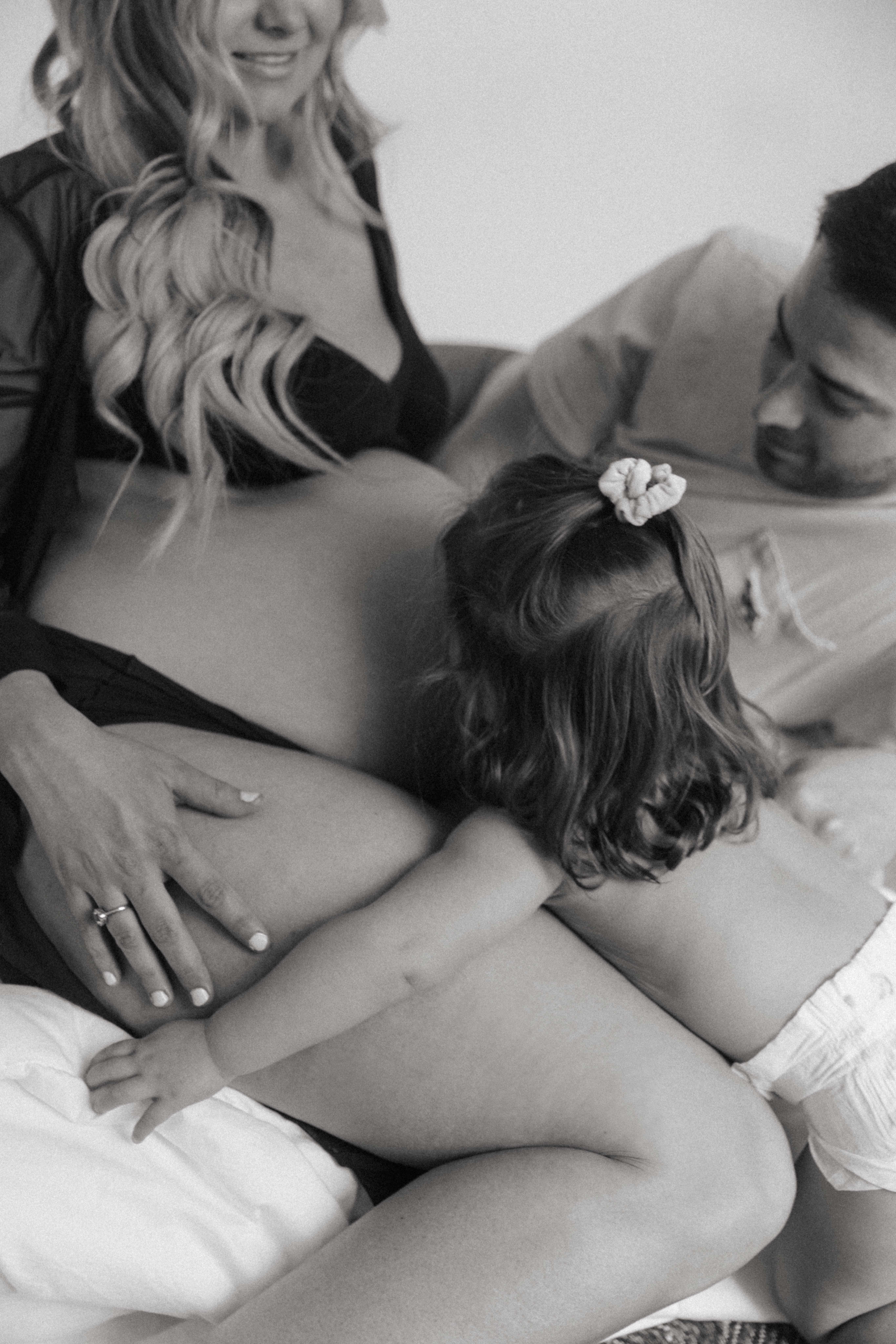 toddler kissing pregnant mom's belly 