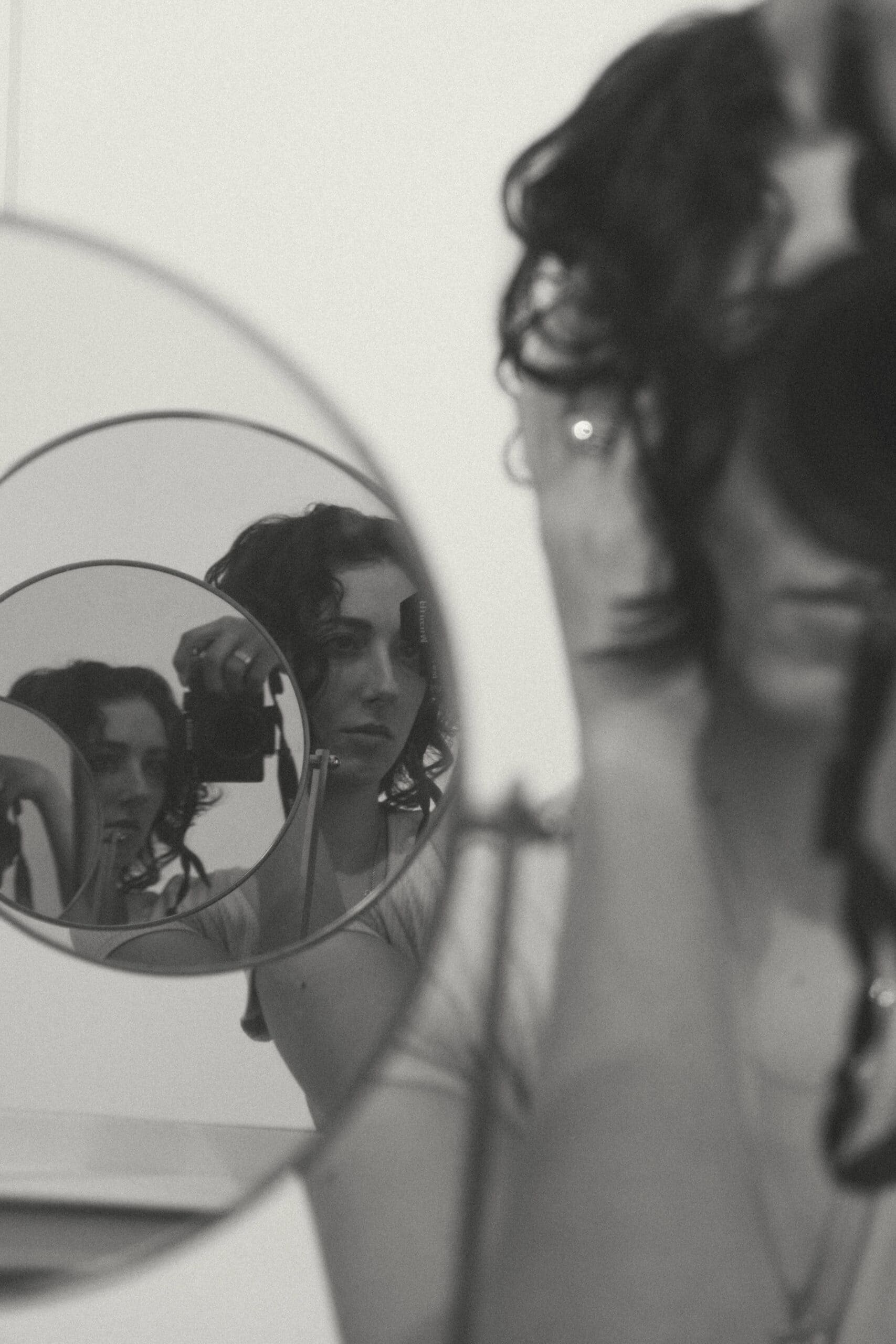 a woman reflecting multiple times through a mirror 