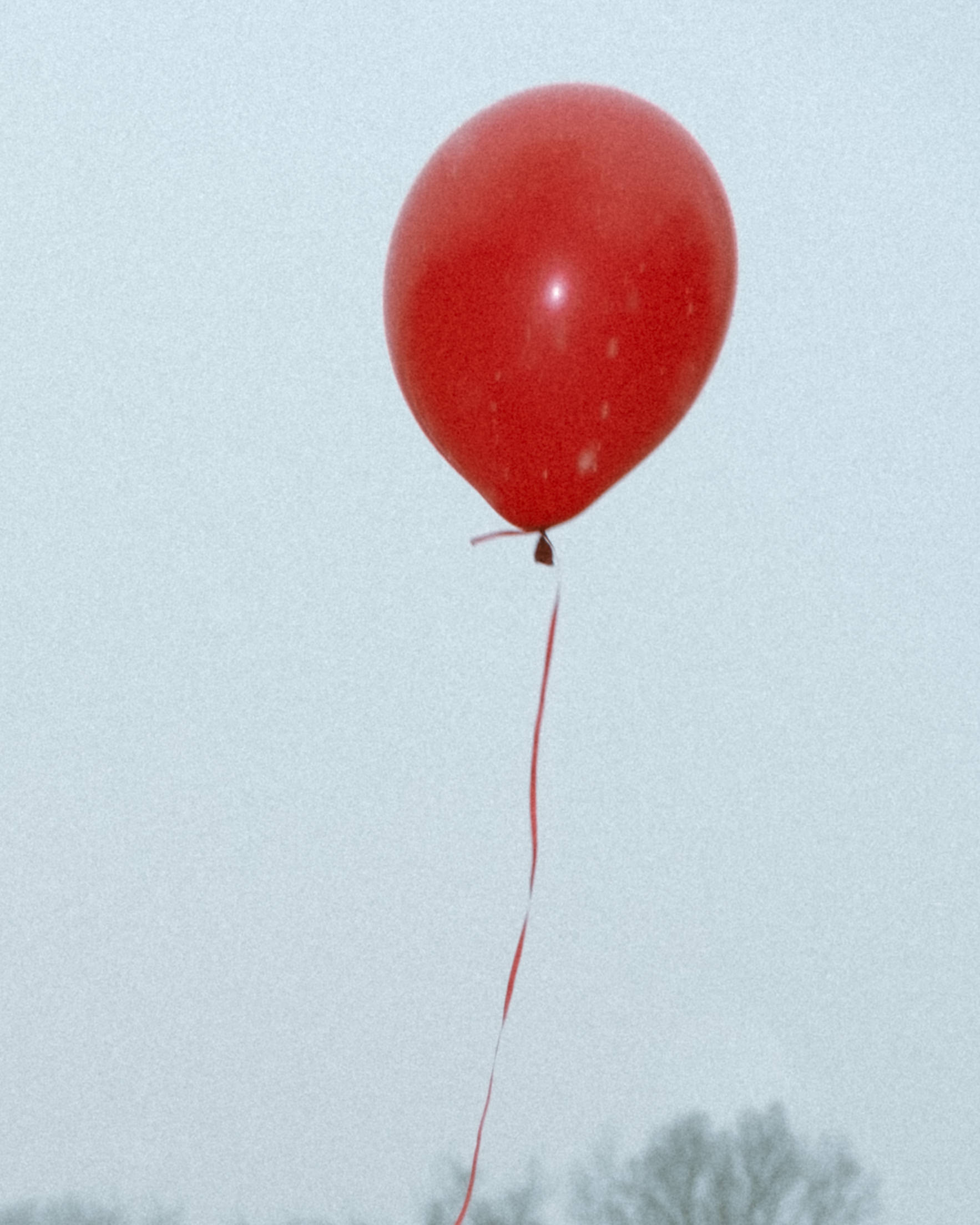a red ballon in the air 