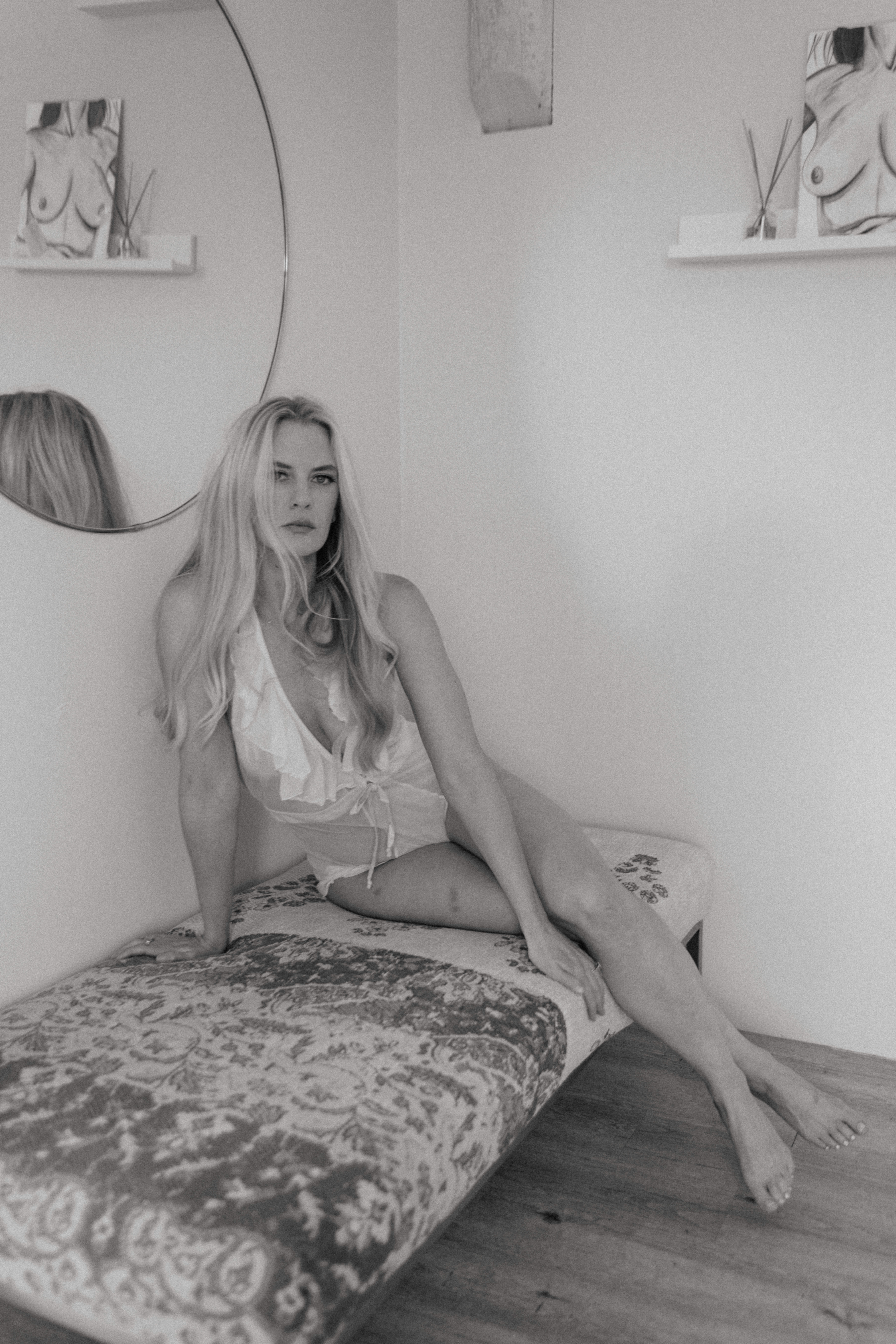 boho boudoir shoot of a woman in lingerie sitting on a bench in studio