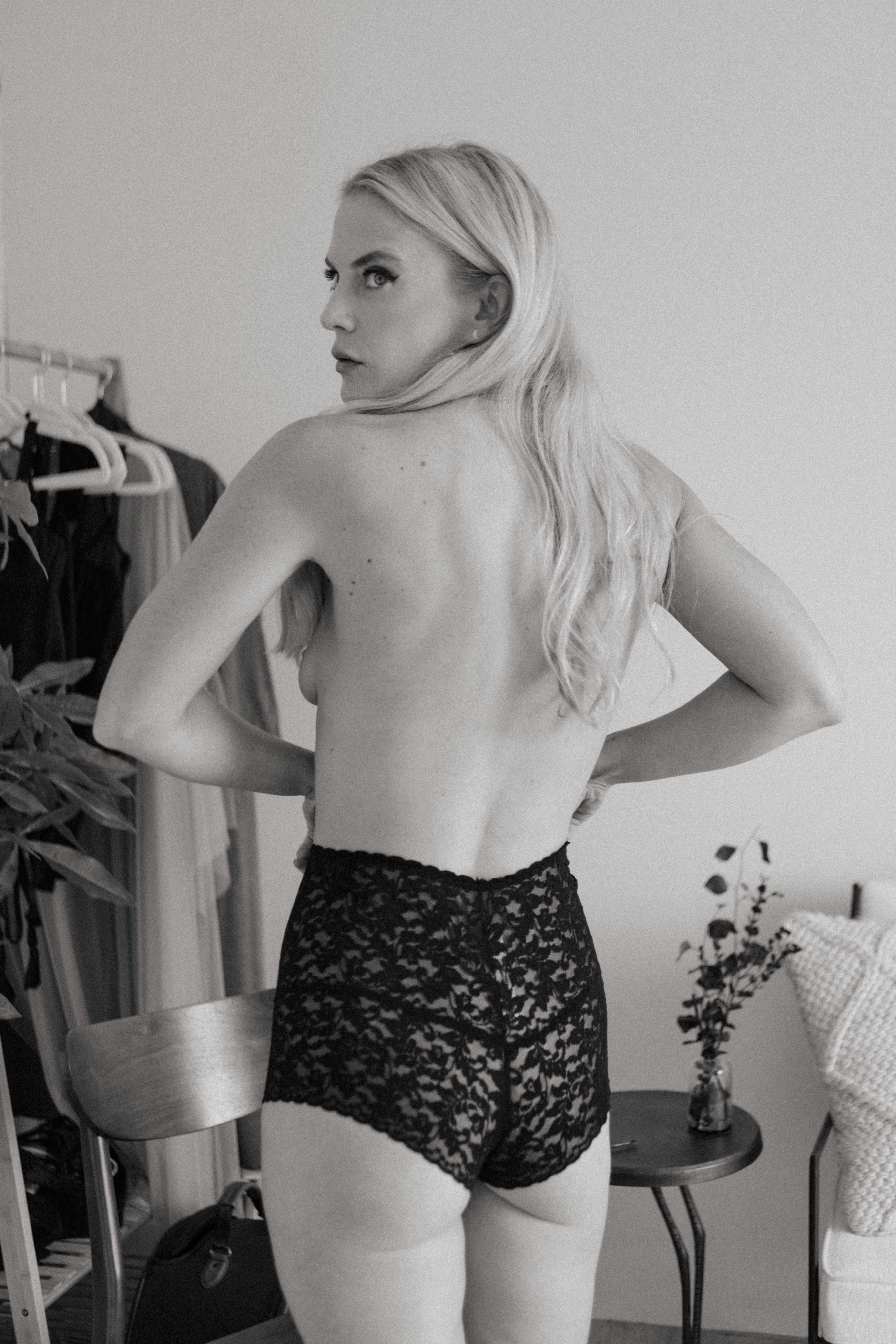 a topless woman's back during a boho boudoir shoot