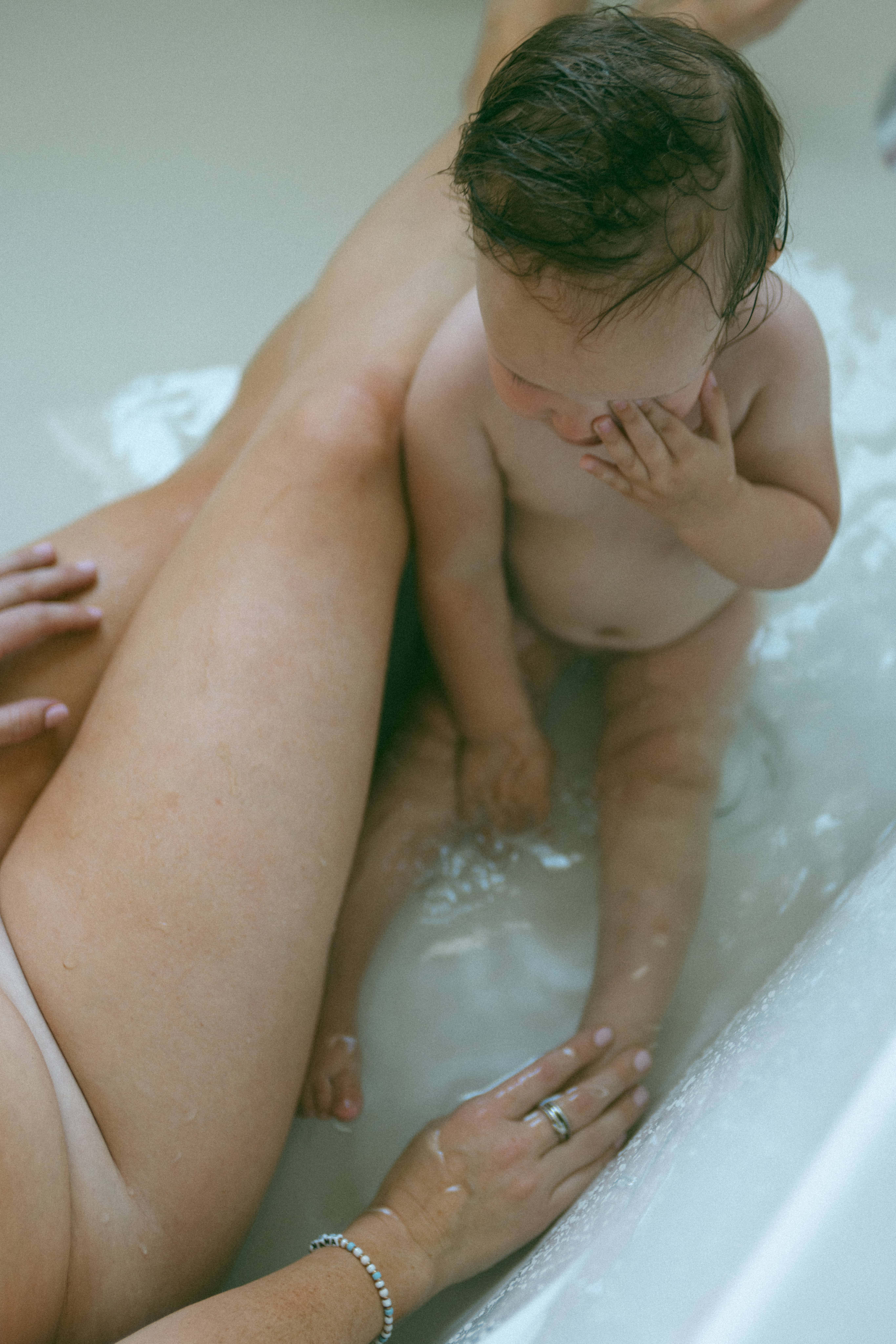 mama and baby in the bath together captured from above by a motherhood photographer 