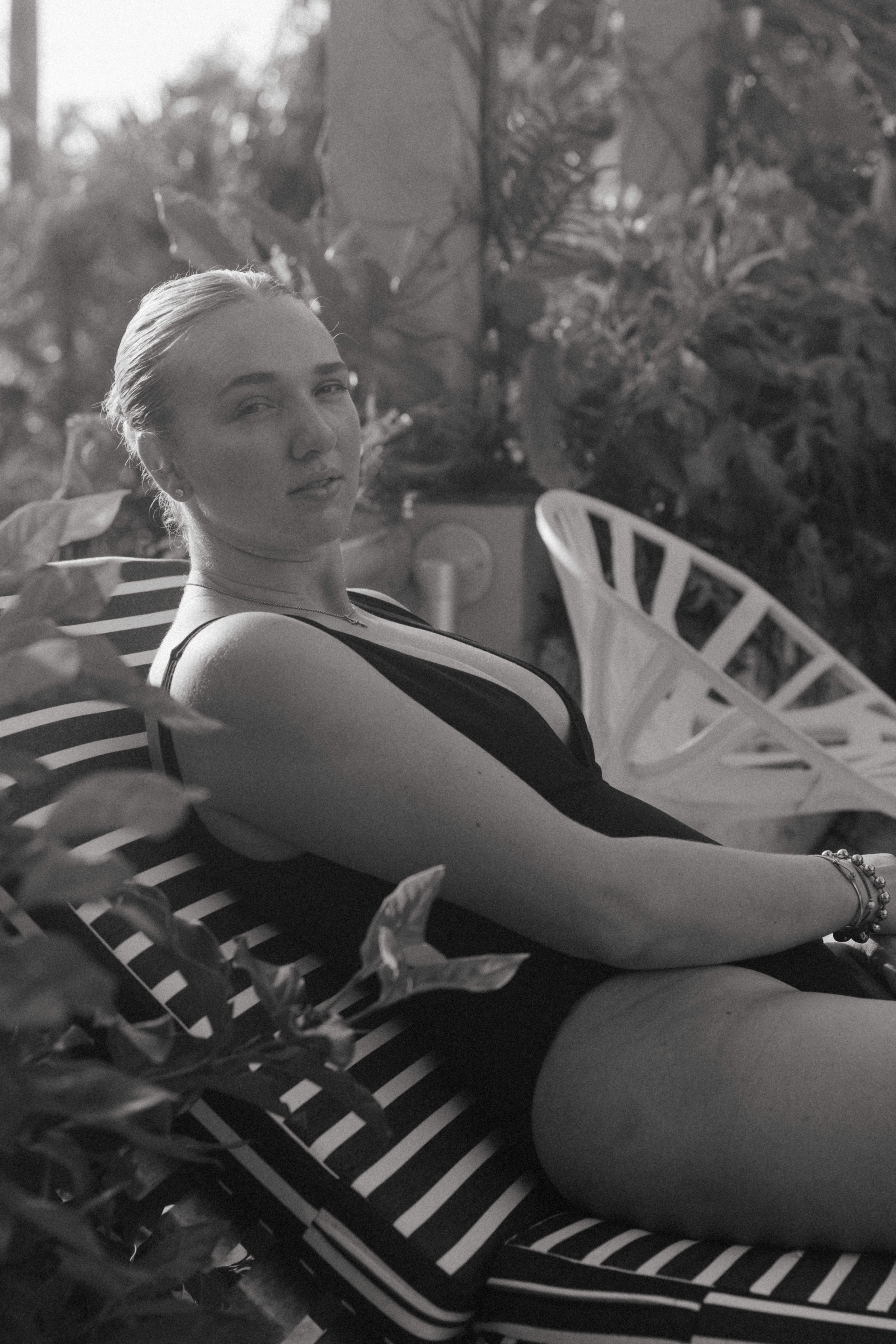 artistic female portrait photography of a woman sitting in a chair in a bikini