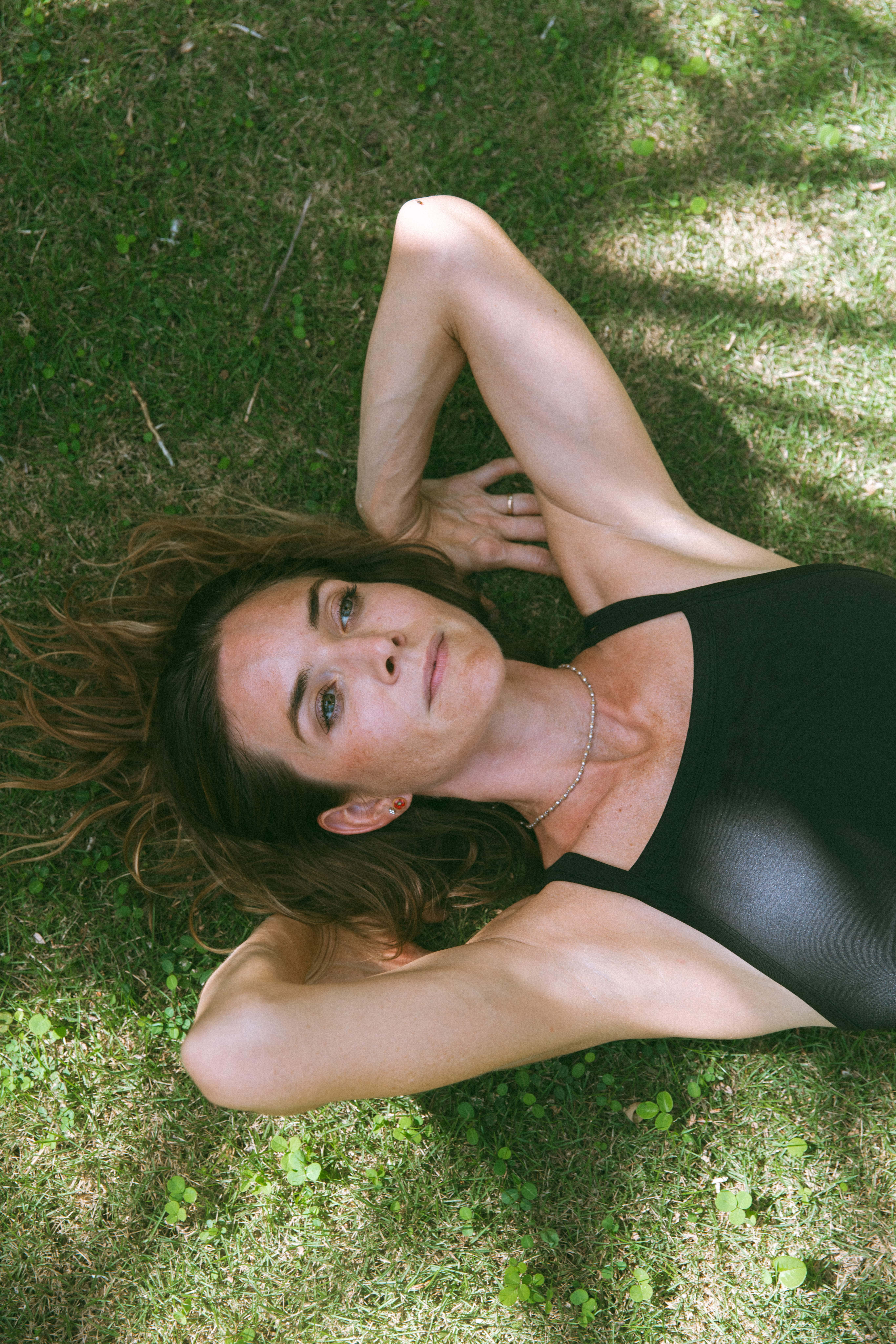 artistic female portrait photography of a woman laying on the ground 