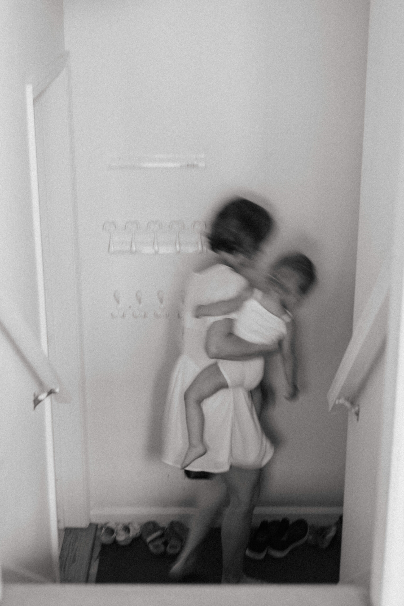 blurry photo of mother carrying baby down the stairs 