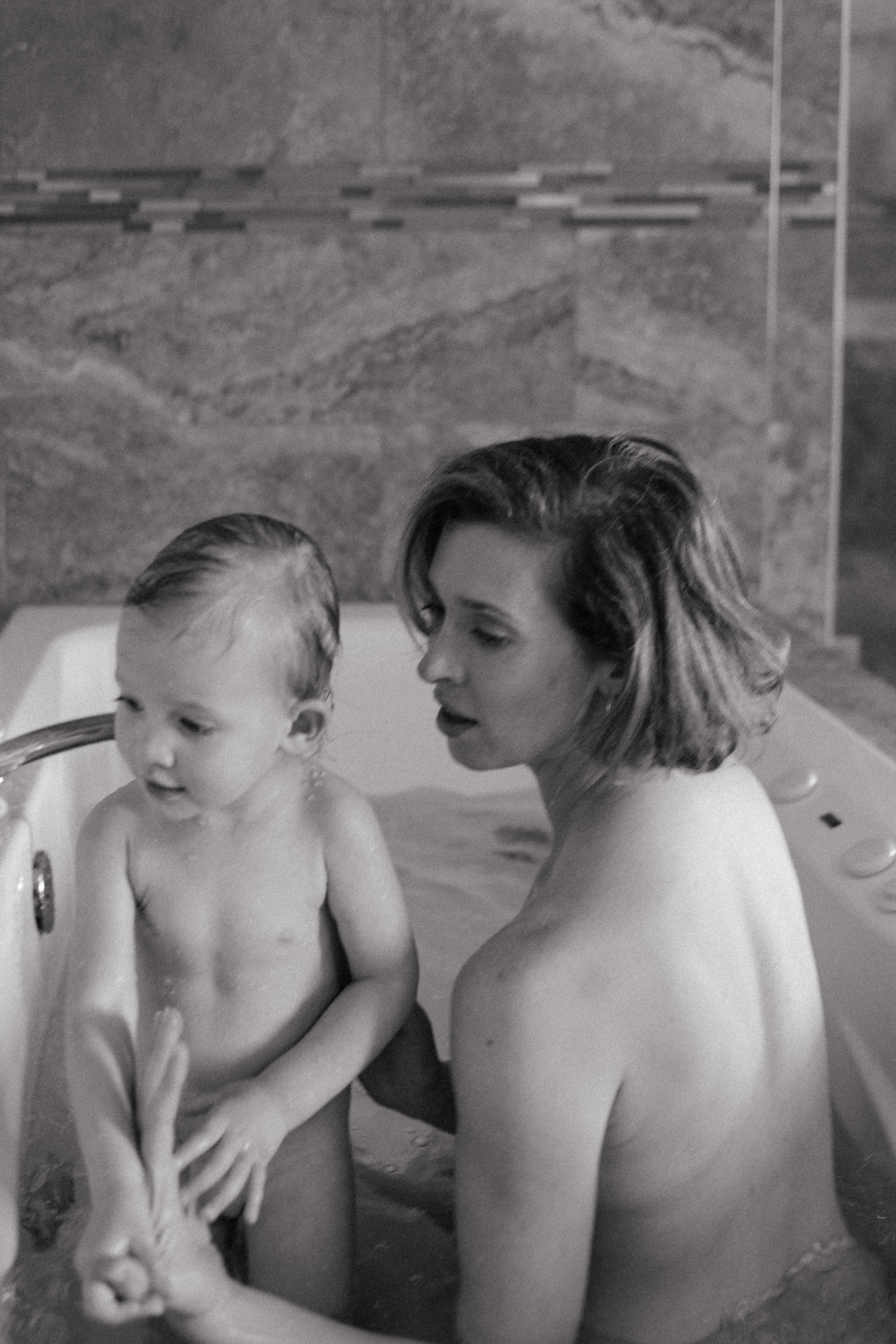 documentary style image of mother and baby in the bath 