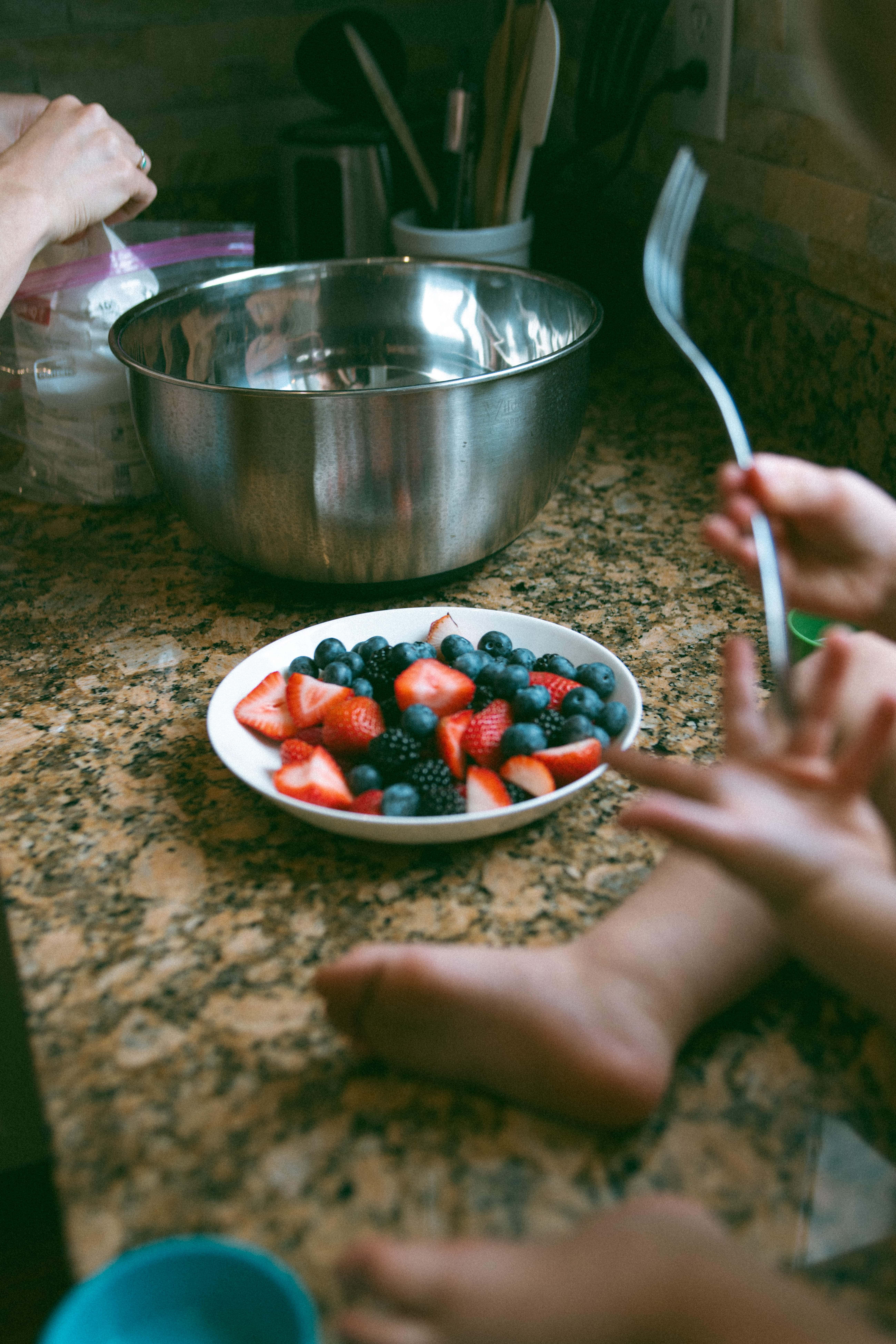bowl of fruit on the counter by the baby