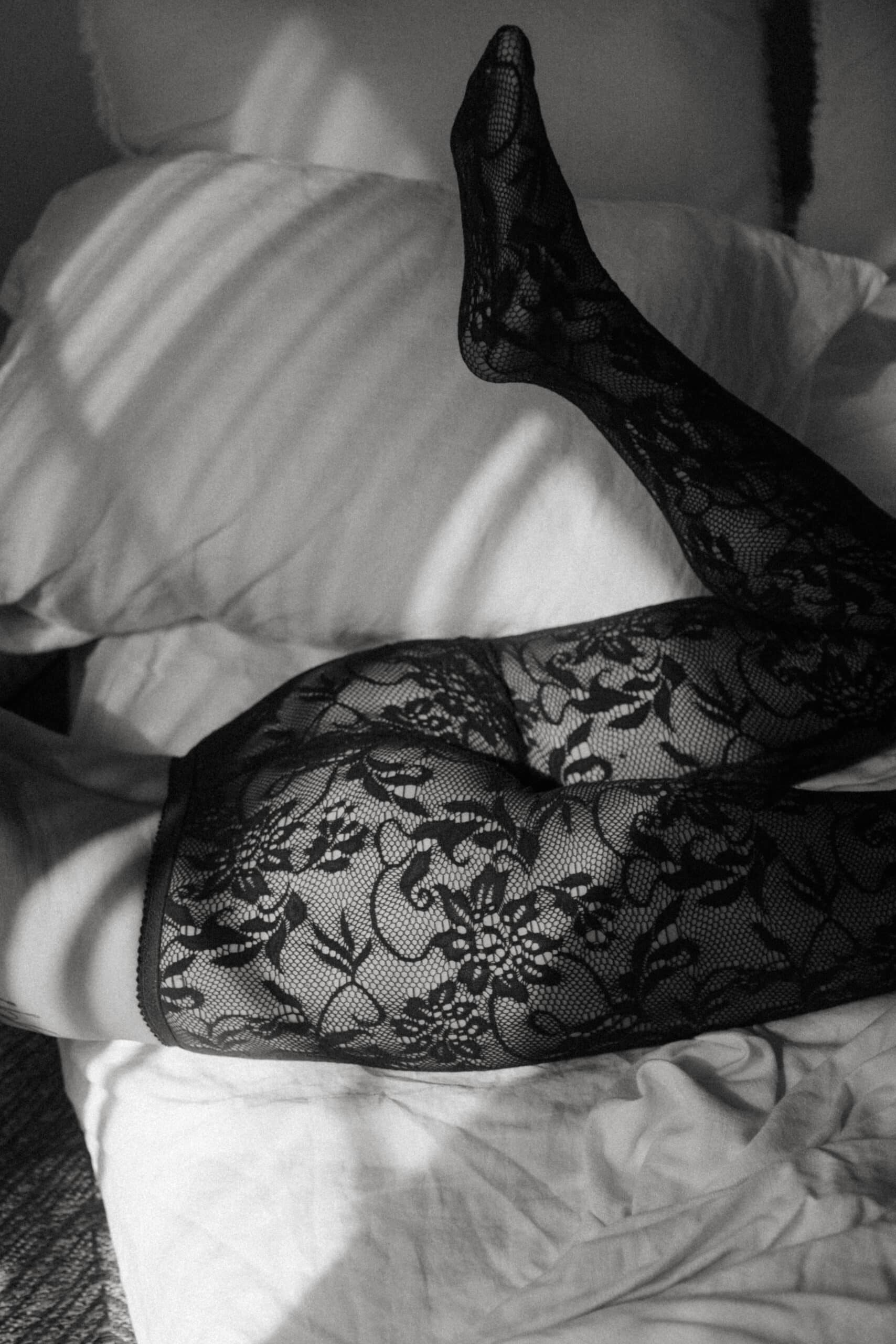 the bottom of a woman wearing lace tights showing what is a boudoir photoshoot