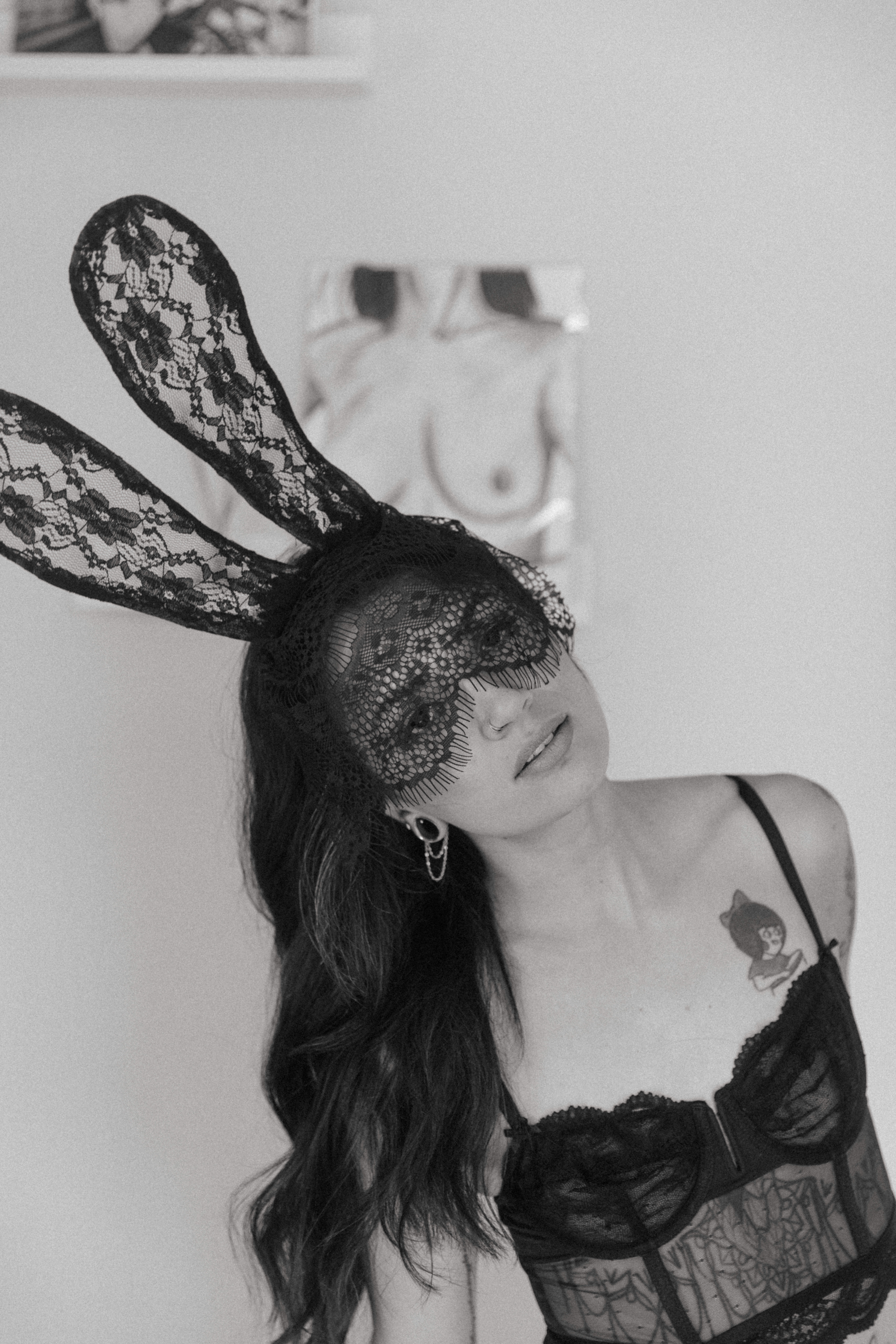 a woman with a mask and lingerie on looking at the camera