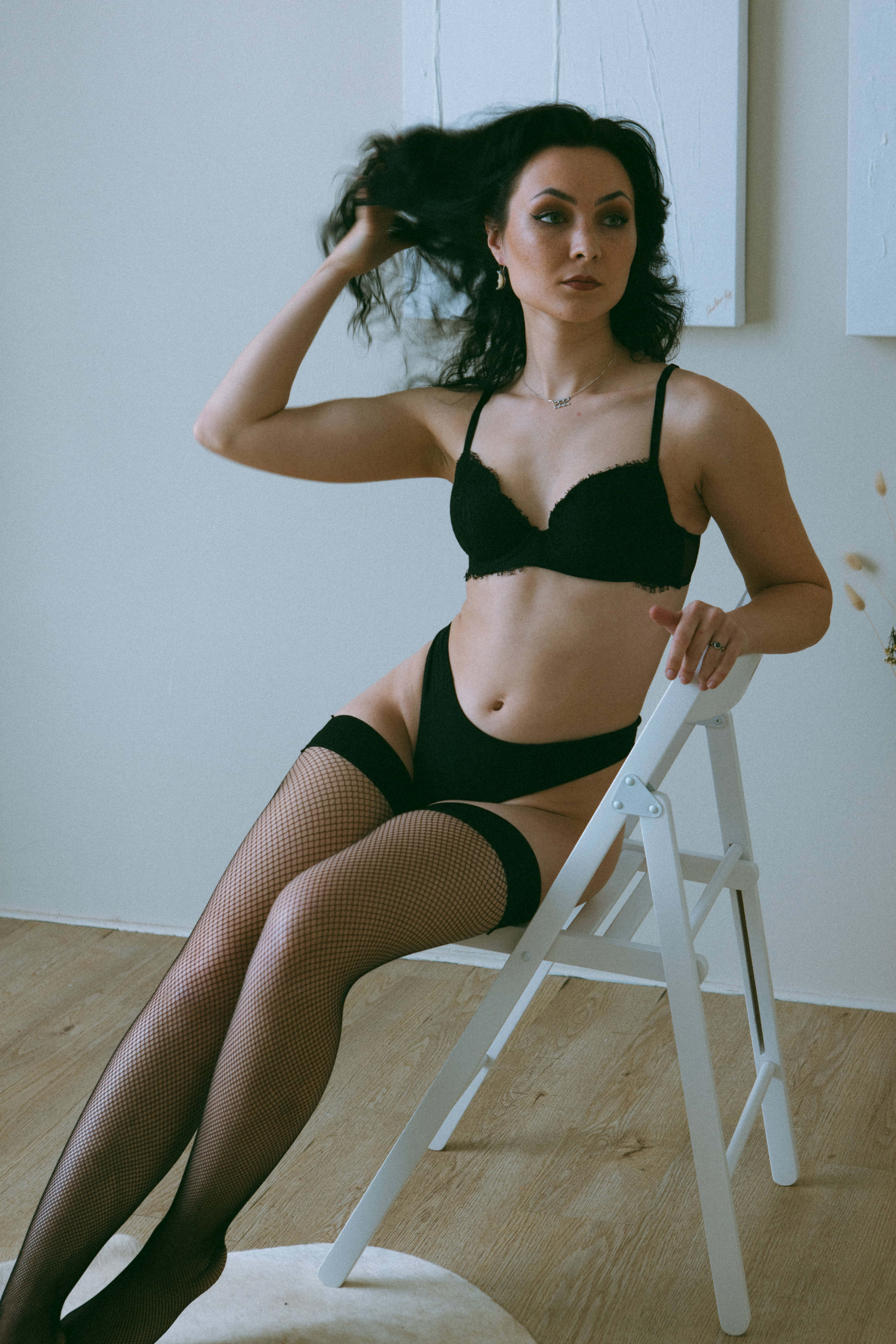 a woman in lingerie sitting on a chair showing what is a boudoir photoshoot