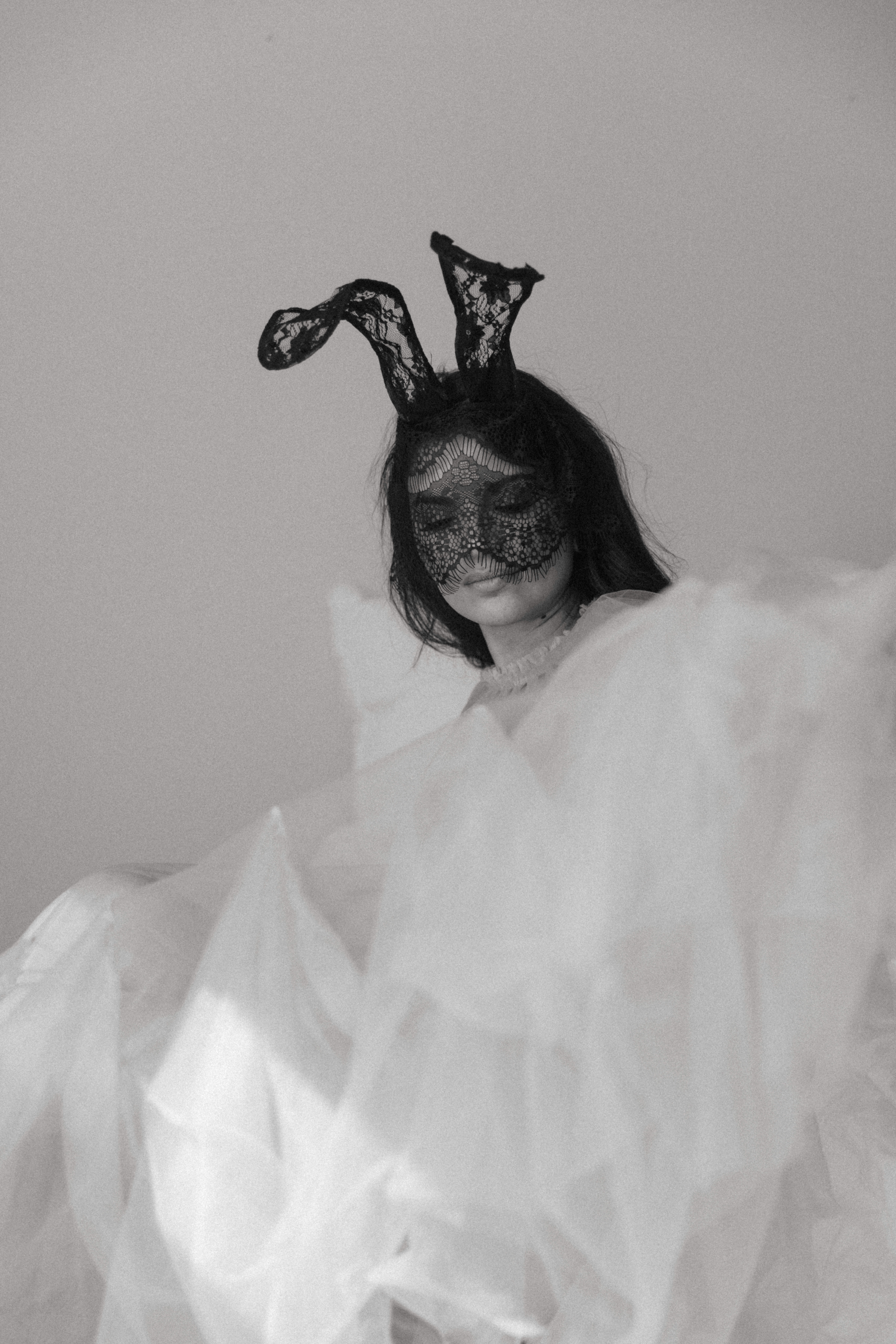 a woman in a mask and a tulle outfit during a maryland boudoir photography session 